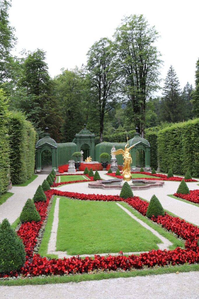 a garden with a statue in the center